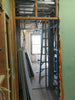 Interior construction framing with drywall stacks and ladder