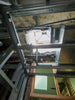 Metal framing in ceiling with insulation and skylight opening.