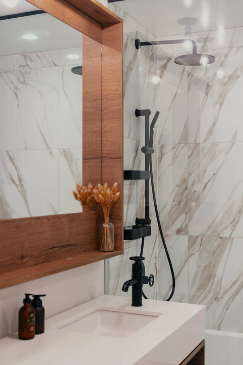 Modern bathroom with marble tile and black fixtures