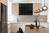 Modern kitchen with sleek cabinets and pendant lights.