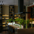 Modern kitchen island with bar stools and bookshelves