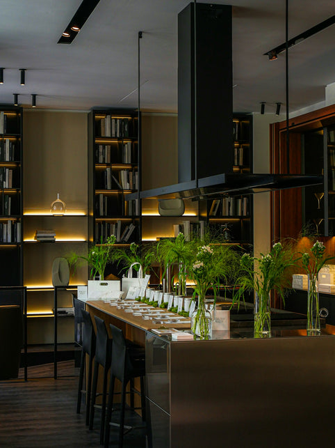 Modern kitchen island with bar stools and bookshelves