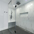 Modern bathroom with glass-enclosed shower and marble walls