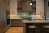 Modern kitchen with island and pendant light.