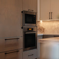 Modern kitchen with built-in oven and microwave.