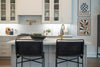 Modern kitchen island with bar stools and artwork