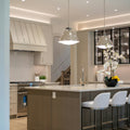 Stylish kitchen with island, pendant lights, and bar stools.