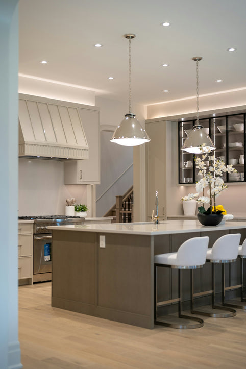 Stylish kitchen with island, pendant lights, and bar stools.