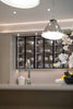 Modern kitchen with illuminated glass cabinets displaying dishes.