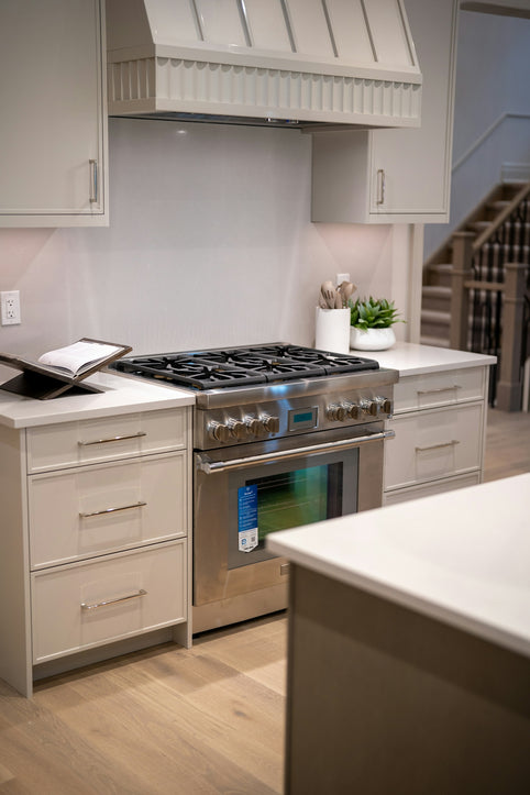 Modern kitchen with stainless steel gas range and oven.