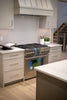 Modern kitchen with stainless steel gas range and oven.