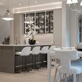 Modern kitchen with island, bar stools, and decorative accents.