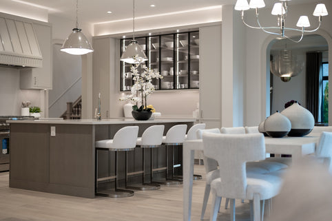 Modern kitchen with island, bar stools, and decorative accents.