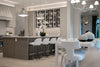 Modern kitchen with island, bar stools, and decorative accents.