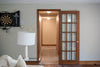 A hallway seen through a glass-paneled door.